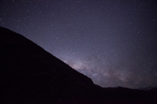 The Milky Way crests over the hills near Lake Pukaki, New Zealand.